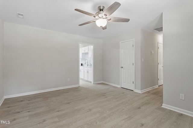 3204 Winfield Ct, Raleigh, NC 27610 - empty room with ceiling fan, light wood-style floors, baseboards, and a sink