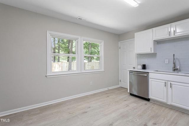 3204 Winfield Ct, Raleigh, NC 27610 - kitchen with dishwasher, a sink, tasteful backsplash, light wood-type flooring, and light countertops