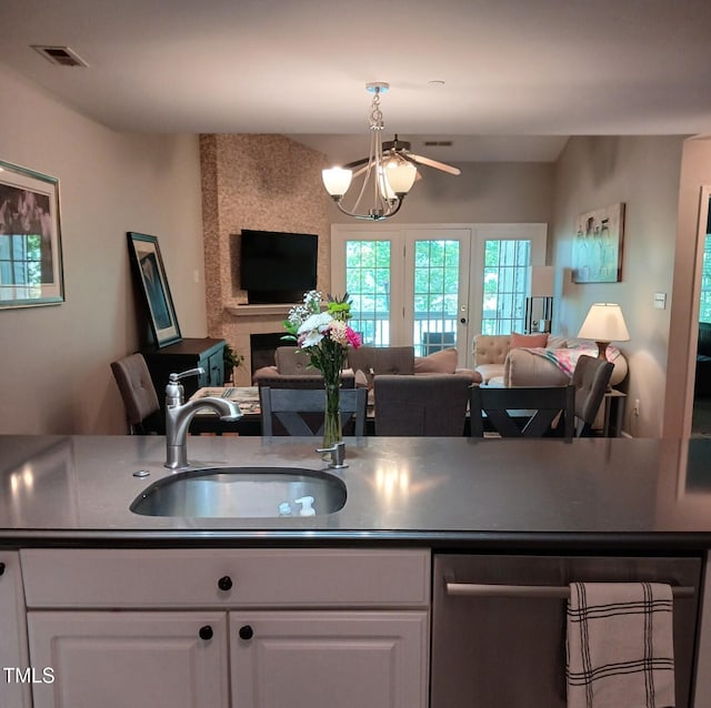 631 Springfork Dr, Cary, NC 27513 - kitchen featuring open floor plan, a sink, white cabinets, dark countertops, and a chandelier