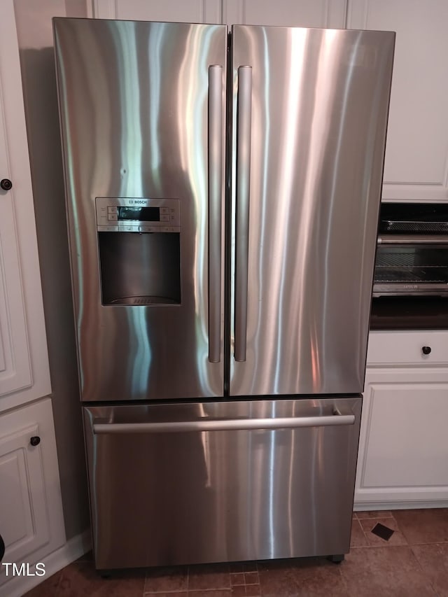 631 Springfork Dr, Cary, NC 27513 - kitchen view of stainless steel fridge with ice dispenser, white cabinetry, and dark countertops