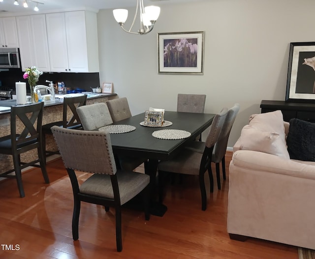 631 Springfork Dr, Cary, NC 27513 - dining room featuring a chandelier and light wood-style floors