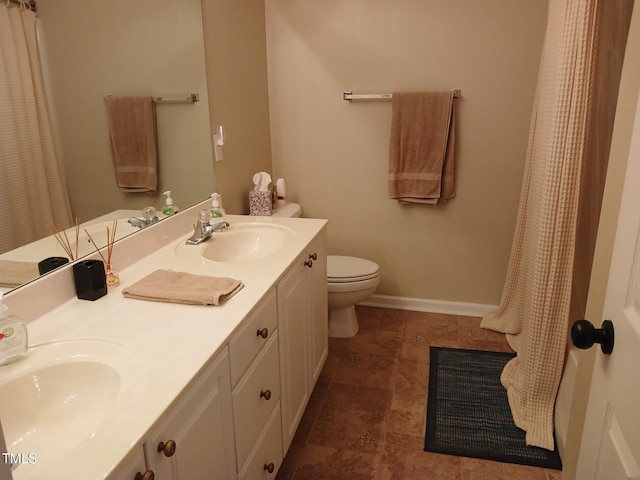 631 Springfork Dr, Cary, NC 27513 - full bathroom with double vanity, toilet, baseboards, and a shower with shower curtain