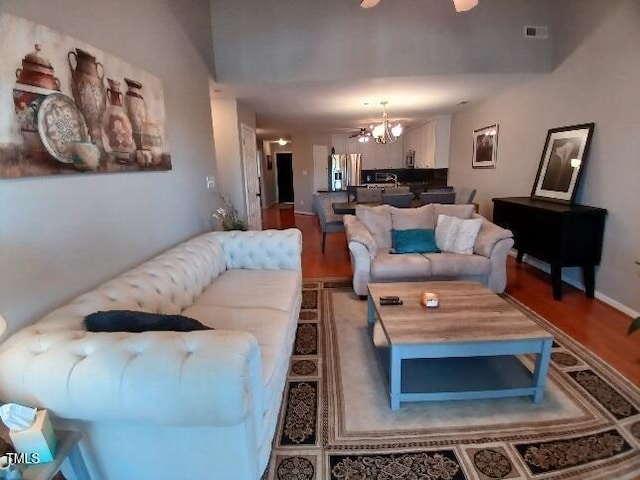631 Springfork Dr, Cary, NC 27513 - living area featuring a chandelier and wood finished floors