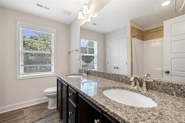 7680 Rufus Johnson Rd, Fayetteville, NC 28306 - full bath featuring baseboards, toilet, double vanity, wood finished floors, and a shower