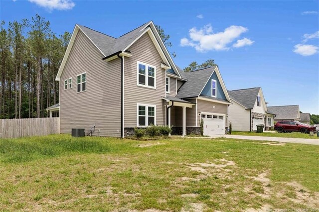 7680 Rufus Johnson Rd, Fayetteville, NC 28306 - craftsman inspired home featuring cooling unit, driveway, and an attached garage