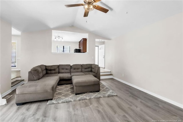 7076 Pantego Dr, Fayetteville, NC 28314 - living room with ceiling fan, wood finished floors, plenty of natural light, baseboards, and lofted ceiling