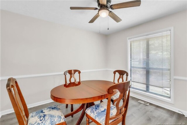 7076 Pantego Dr, Fayetteville, NC 28314 - dining room featuring healthy amount of natural light, wood finished floors, baseboards, and ceiling fan