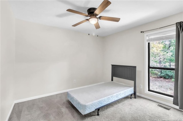 7076 Pantego Dr, Fayetteville, NC 28314 - carpeted bedroom with baseboards and a ceiling fan