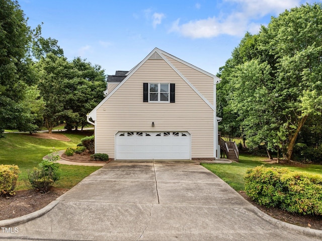 100 Silver Lining Ln, Cary, NC 27513 - view of home's exterior with an attached garage, a lawn, concrete driveway, and stairway