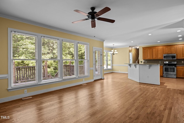 100 Silver Lining Ln, Cary, NC 27513 - kitchen featuring stainless steel appliances, crown molding, a chandelier, a kitchen bar, and a ceiling fan