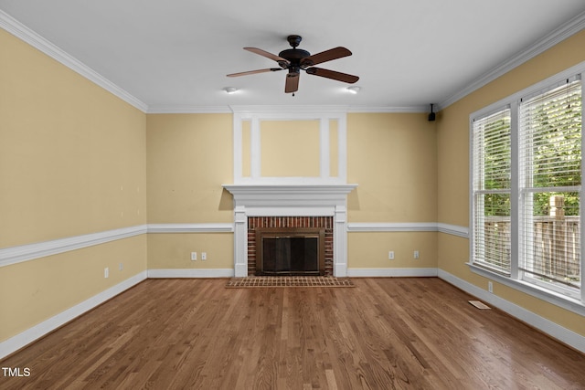 100 Silver Lining Ln, Cary, NC 27513 - unfurnished living room featuring a ceiling fan, wood finished floors, crown molding, a fireplace, and baseboards