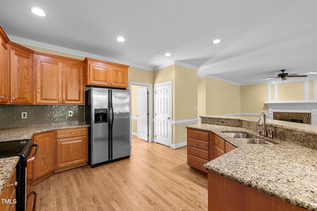 100 Silver Lining Ln, Cary, NC 27513 - kitchen with stainless steel appliances, a sink, ceiling fan, ornamental molding, and light wood-style flooring