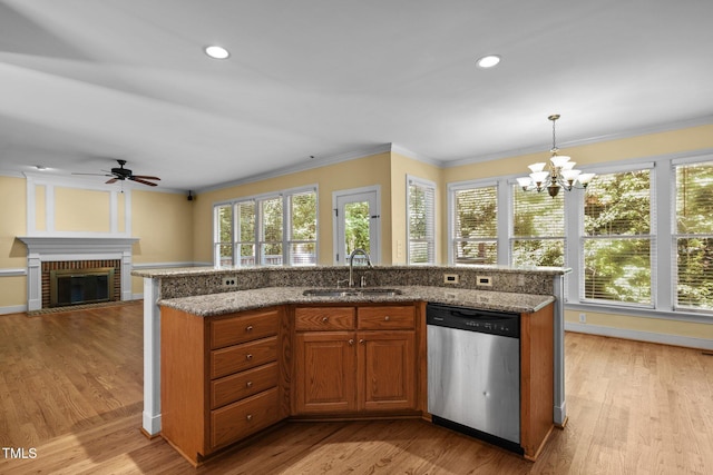 100 Silver Lining Ln, Cary, NC 27513 - kitchen with stainless steel dishwasher, a sink, crown molding, ceiling fan, and a fireplace