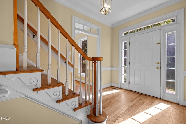100 Silver Lining Ln, Cary, NC 27513 - foyer entrance with stairway, a chandelier, light wood finished floors, and crown molding