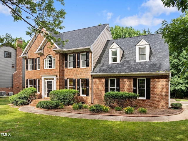100 Silver Lining Ln, Cary, NC 27513 - view of front of property with brick siding, a front lawn, central AC unit, and a shingled roof