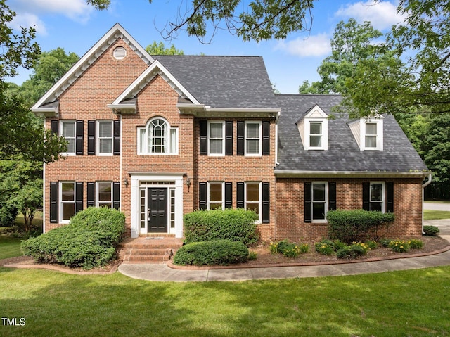 100 Silver Lining Ln, Cary, NC 27513 - view of front facade with brick siding, a front yard, and a shingled roof