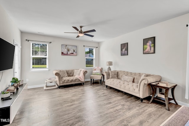 6760 Longitude Cir, Sims, NC 27880 - living area featuring wood finished floors, ceiling fan, and baseboards