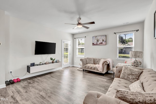 6760 Longitude Cir, Sims, NC 27880 - living area with ceiling fan, plenty of natural light, wood finished floors, and baseboards