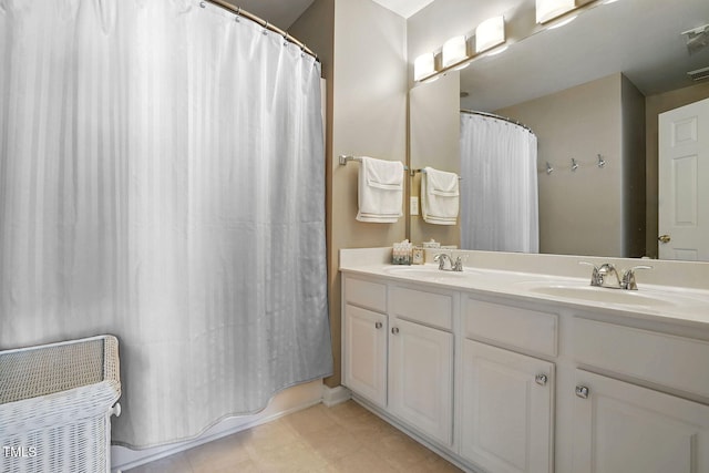 4907 Wyatt Brook Way, Raleigh, NC 27609 - bathroom with double vanity, curtained shower, and tile patterned floors