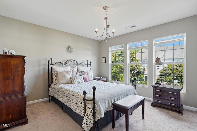 4907 Wyatt Brook Way, Raleigh, NC 27609 - bedroom with light colored carpet, baseboards, and a chandelier