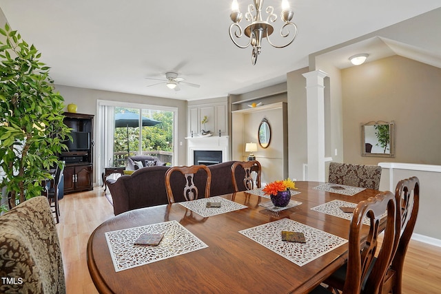 4907 Wyatt Brook Way, Raleigh, NC 27609 - dining area featuring a ceiling fan, a fireplace, light wood-style floors, and a chandelier