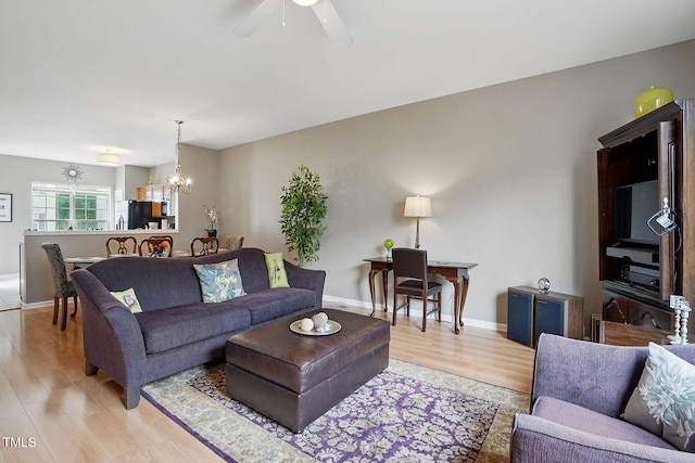 4907 Wyatt Brook Way, Raleigh, NC 27609 - living room featuring light wood finished floors, a chandelier, a ceiling fan, and baseboards