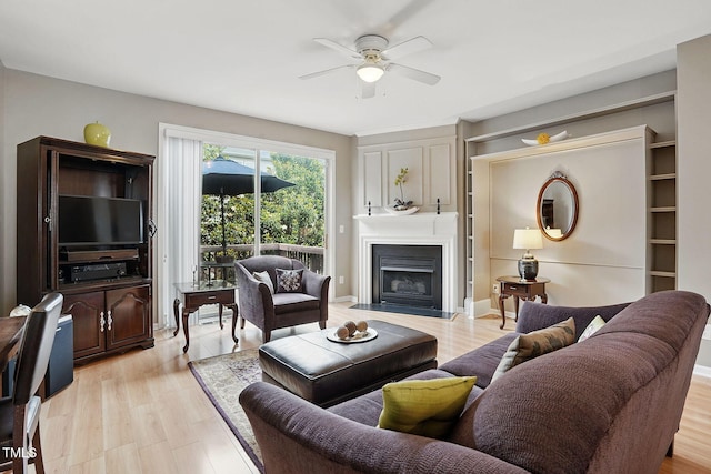 4907 Wyatt Brook Way, Raleigh, NC 27609 - living area featuring ceiling fan, a fireplace, and light wood-type flooring