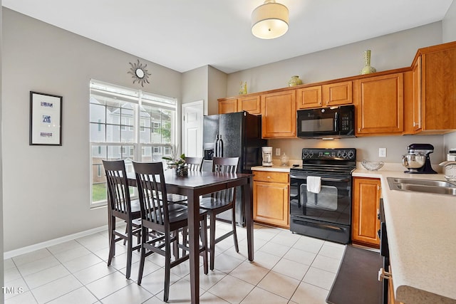 4907 Wyatt Brook Way, Raleigh, NC 27609 - kitchen featuring black appliances, light countertops, a sink, and light tile patterned floors