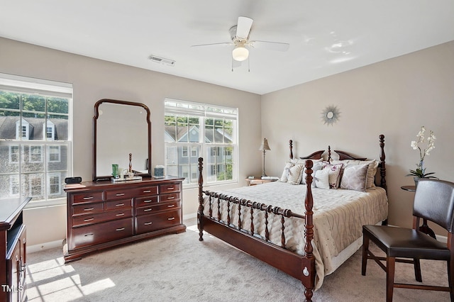 4907 Wyatt Brook Way, Raleigh, NC 27609 - bedroom featuring multiple windows, baseboards, light carpet, and ceiling fan
