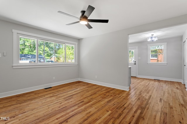 833 Brigham Rd, Raleigh, NC 27610 - spare room with light wood-style floors, baseboards, a chandelier, and a ceiling fan