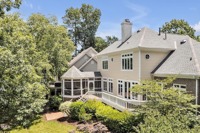 81002 Alexander, Chapel Hill, NC 27517 - back of property with a sunroom, a wooden deck, a shingled roof, and a chimney