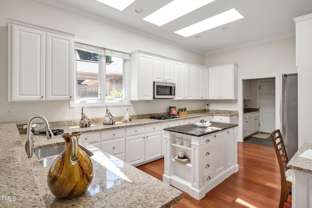 81002 Alexander, Chapel Hill, NC 27517 - kitchen featuring ornamental molding, appliances with stainless steel finishes, light stone counters, and white cabinetry