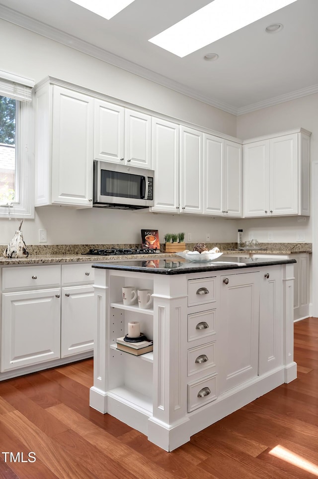 81002 Alexander, Chapel Hill, NC 27517 - kitchen with stainless steel microwave, open shelves, crown molding, white cabinets, and light wood-style floors