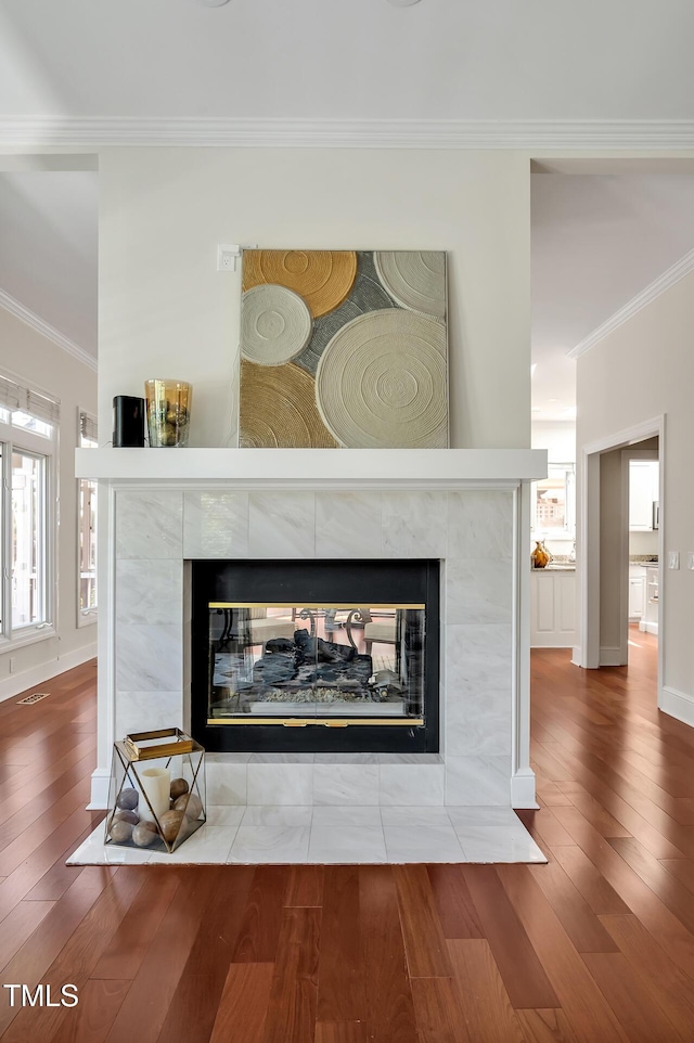 81002 Alexander, Chapel Hill, NC 27517 - detailed view of a tile fireplace, crown molding, and wood finished floors