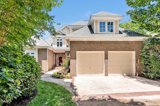 81002 Alexander, Chapel Hill, NC 27517 - view of front facade with brick siding, roof with shingles, driveway, and an attached garage