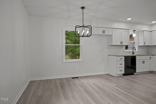 111 S Gaylee Lake Dr, Wendell, NC 27591 - kitchen with dishwasher, light wood-style floors, a chandelier, backsplash, and baseboards