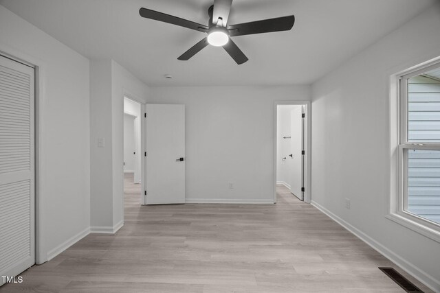 111 S Gaylee Lake Dr, Wendell, NC 27591 - unfurnished bedroom with light wood-style floors, multiple windows, and baseboards