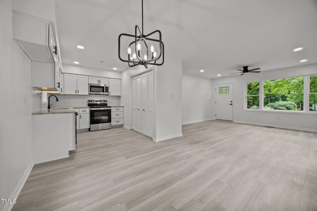 111 S Gaylee Lake Dr, Wendell, NC 27591 - kitchen featuring appliances with stainless steel finishes, recessed lighting, baseboards, open floor plan, and white cabinetry