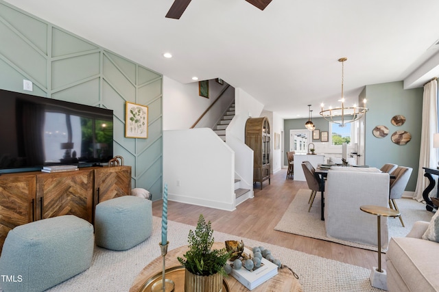 1408 Sawyer Rd Unit 103, Raleigh, NC 27610 - living room featuring stairway, wood finished floors, a chandelier, ceiling fan, and recessed lighting