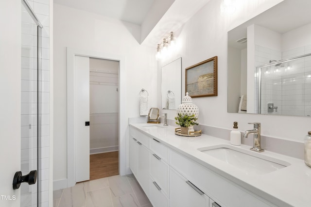 1408 Sawyer Rd Unit 103, Raleigh, NC 27610 - bathroom with double vanity, a tile shower, and a walk in closet