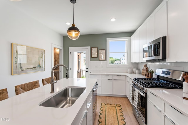 1408 Sawyer Rd Unit 103, Raleigh, NC 27610 - kitchen with stainless steel appliances, light wood-style floors, light countertops, tasteful backsplash, and recessed lighting