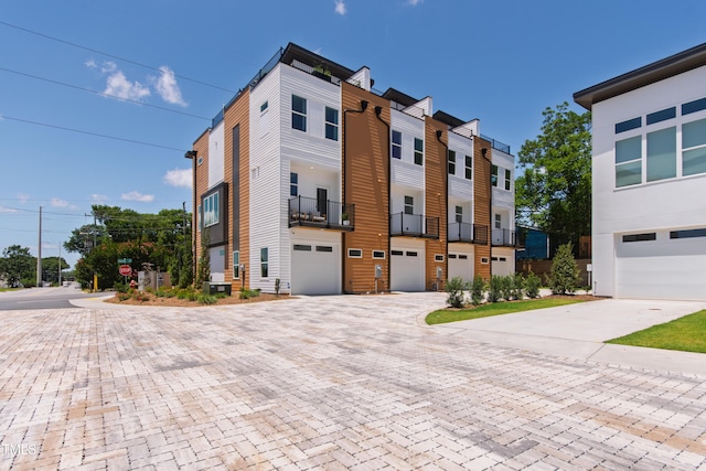 1408 Sawyer Rd Unit 103, Raleigh, NC 27610 - view of building exterior with driveway and a garage
