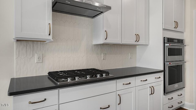 121 Gilmer St, Fuquay Varina, NC 27526 - kitchen with wall chimney exhaust hood, stainless steel appliances, dark countertops, and backsplash