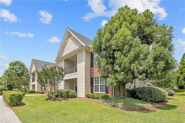 159 Gallery Dr Unit 103, Spring Lake, NC 28390 - view of property exterior with a lawn and brick siding