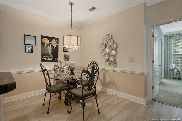 159 Gallery Dr Unit 103, Spring Lake, NC 28390 - dining space featuring wood finished floors, crown molding, baseboards, and a chandelier