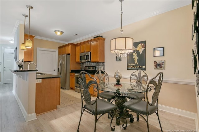 159 Gallery Dr Unit 103, Spring Lake, NC 28390 - dining space featuring ornamental molding, light wood finished floors, and baseboards