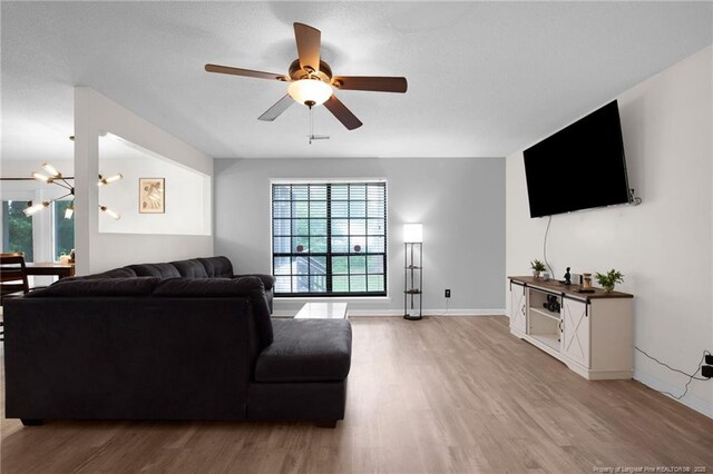 3855 Sturbridge Dr, Hope Mills, NC 28348 - living room featuring healthy amount of natural light, wood finished floors, and a chandelier