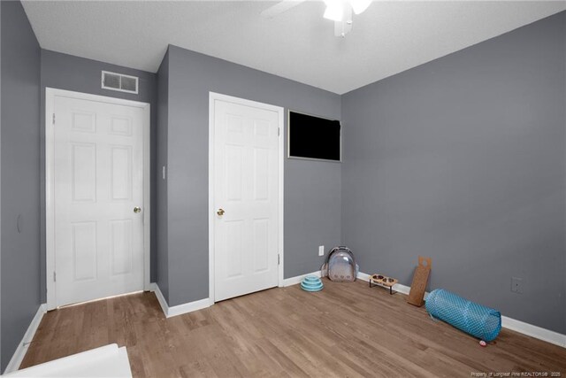 3855 Sturbridge Dr, Hope Mills, NC 28348 - unfurnished bedroom with wood finished floors, baseboards, and a ceiling fan
