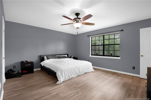 3855 Sturbridge Dr, Hope Mills, NC 28348 - bedroom with wood finished floors, baseboards, and ceiling fan
