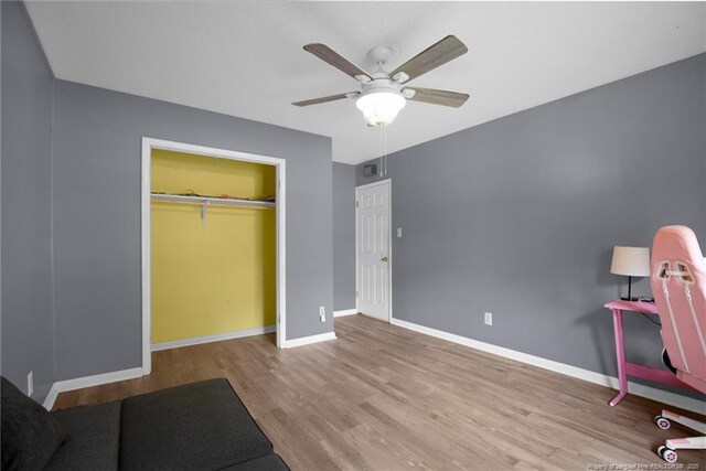 3855 Sturbridge Dr, Hope Mills, NC 28348 - unfurnished bedroom with wood finished floors, baseboards, ceiling fan, and a closet